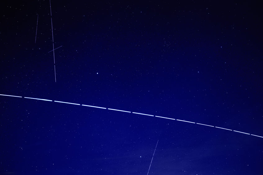 A string of SpaceX Starlink satellites visible in the night sky