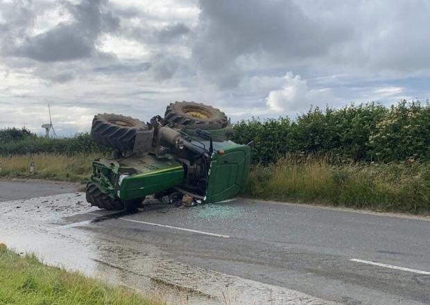 Dramatic photos of the incident show a tractor overturned on its side (Photo: Padstow Community Fire Station)