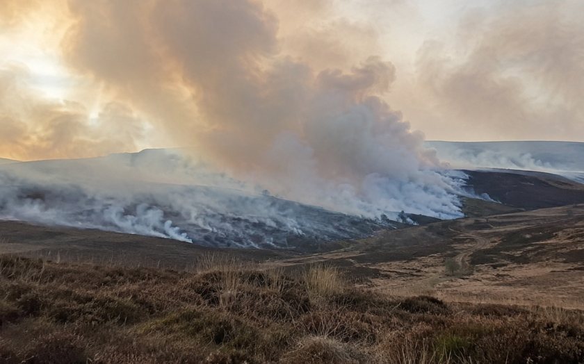 A moorland blaze sends smoke across the landscape amid renewed debate over land management and wildfire prevention