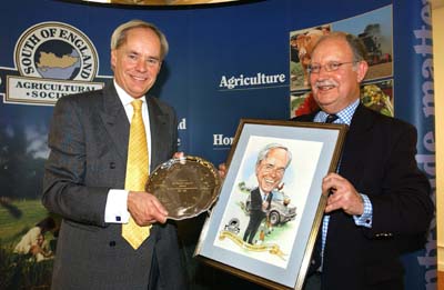 Pictured is outgoing chairman David Allam (left) being presented with a silver salver and humorous tribute by new chairman Brian Williams.