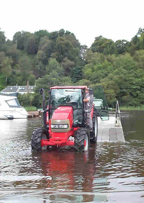 Easy does it – the new McCormick CX95 tractor makes its way through Loch Lomond’s waters before climbing the pontoon ramp.