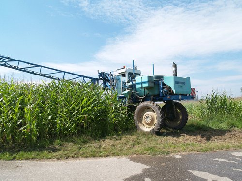 A high-clearance tractor is used to apply insecticides to control the Western corn rootworm. A number of different active ingredients have been granted restricted approval for this purpose